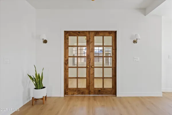 a view of empty room with wooden floor