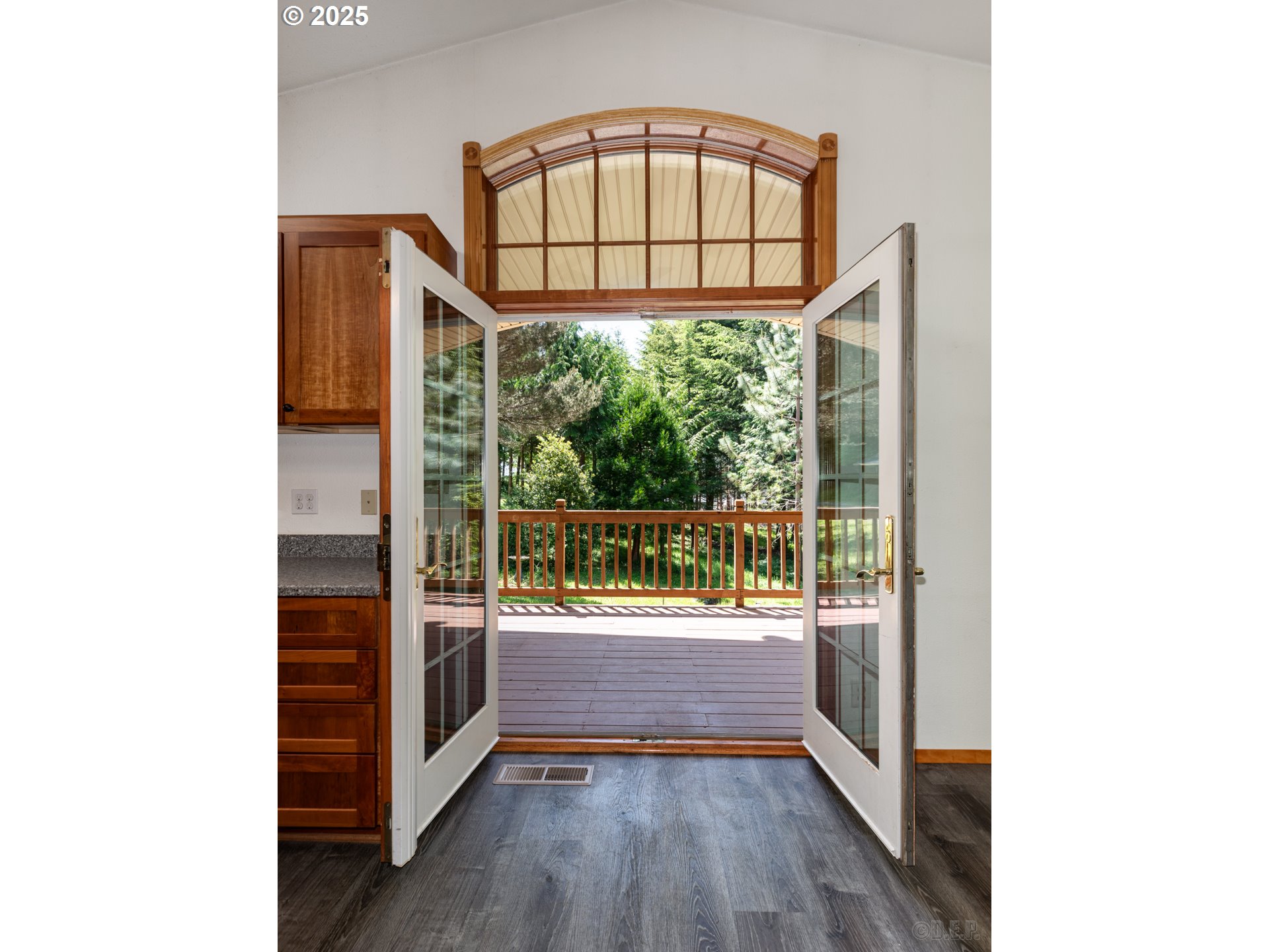 25363 Wonderly Road Rainier, OR 97048 - Photo 4 of 40 a view of a hallway with a large window and wooden floor