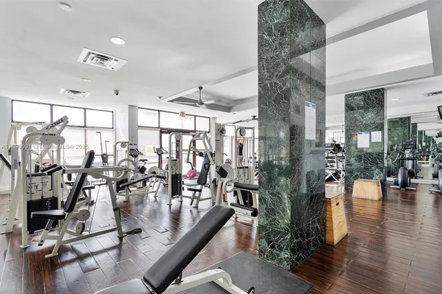 a view of a room with lots of gym equipment