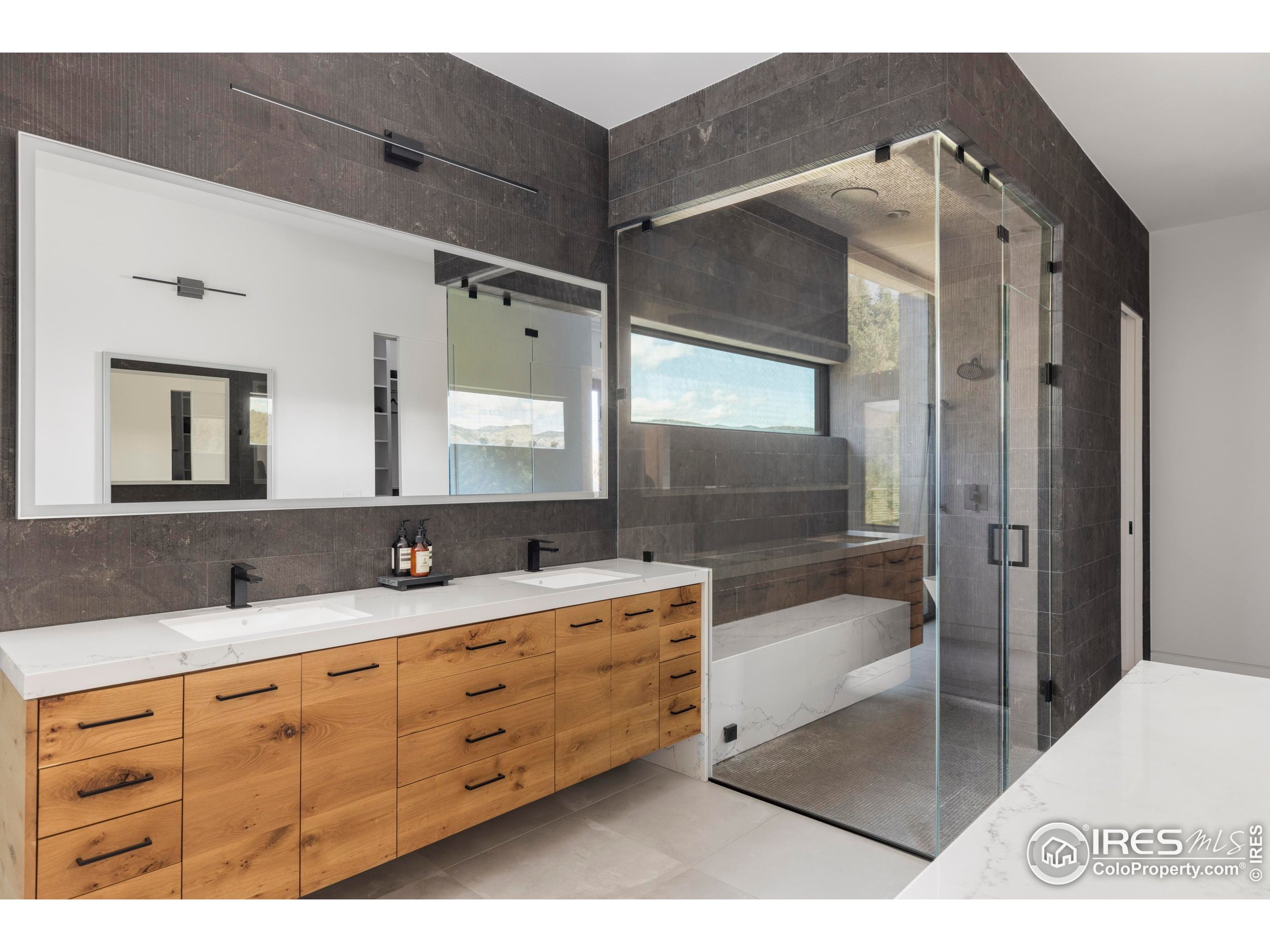 1151 Timber Lane Boulder, CO 80304 - Photo 24 of 33 a bathroom with a granite countertop sink mirror bathtub and double