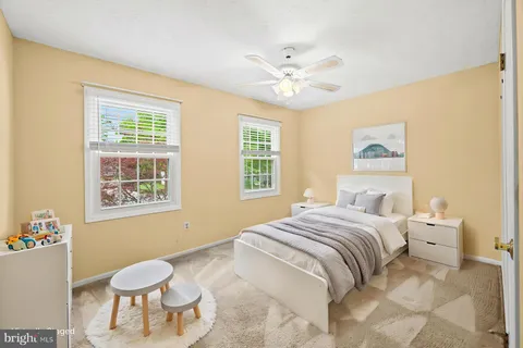 a spacious bathroom with a granite countertop double vanity sink a mirror and a bathtub