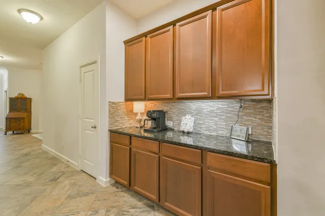 a dining room with furniture potted plants and wooden floor