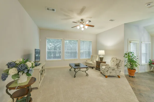 a dining room with furniture and a chandelier