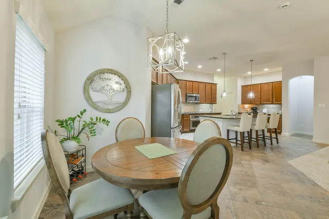 a bedroom with a bed dresser and a large window