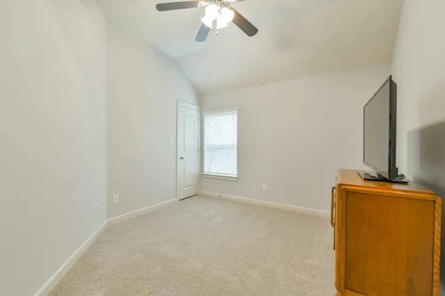 en empty room with furniture and flat screen tv