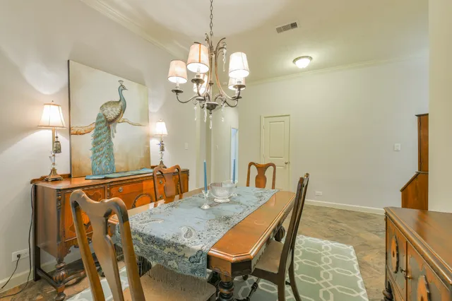 a dining room with furniture and a chandelier