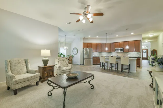 a kitchen with a sink stove and living room view