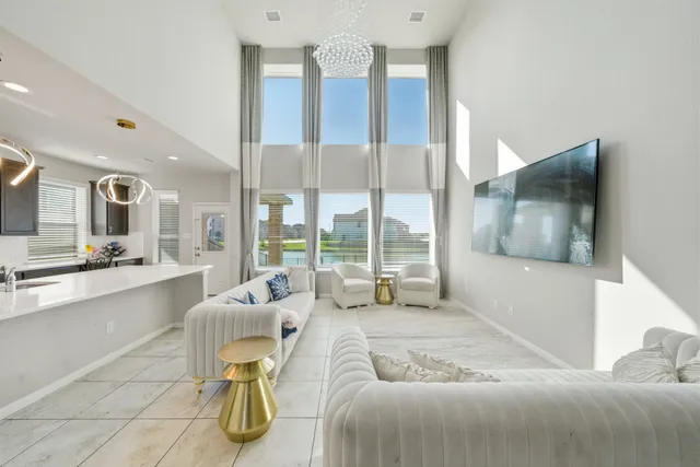 a spacious bedroom with a bed and glass windows