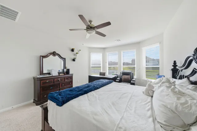 a bedroom with a bed and window