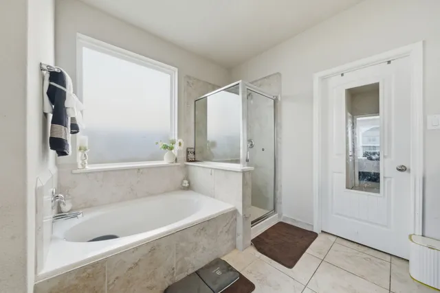 a bathroom with a bathtub and a shower
