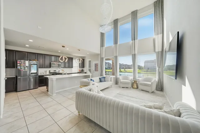 a large bedroom with a large bed and tv