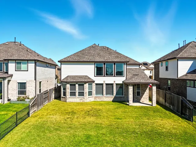 an aerial view of a house with a swimming pool yard and outdoor seating