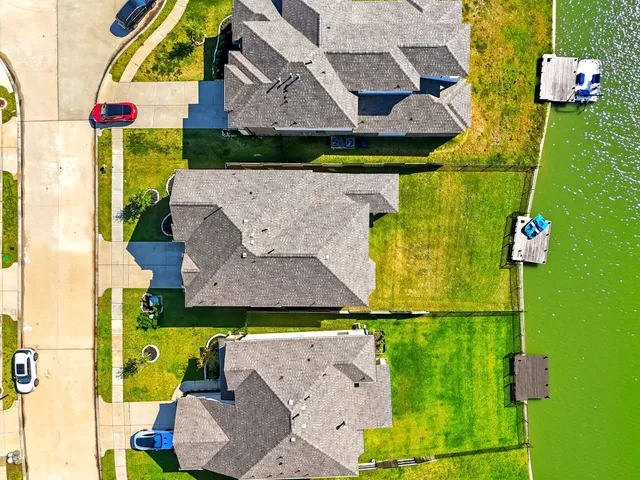 an aerial view of a house with a yard