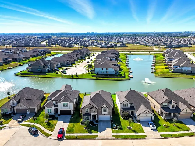 an aerial view of a house with a swimming pool