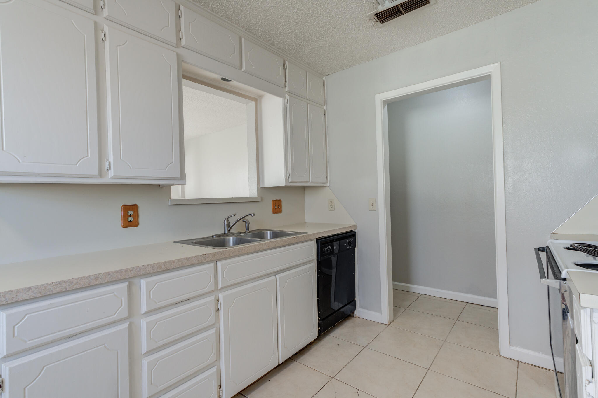6212 22nd Street Lubbock, TX 79407 - Photo 11 of 24 a kitchen with a sink and cabinets