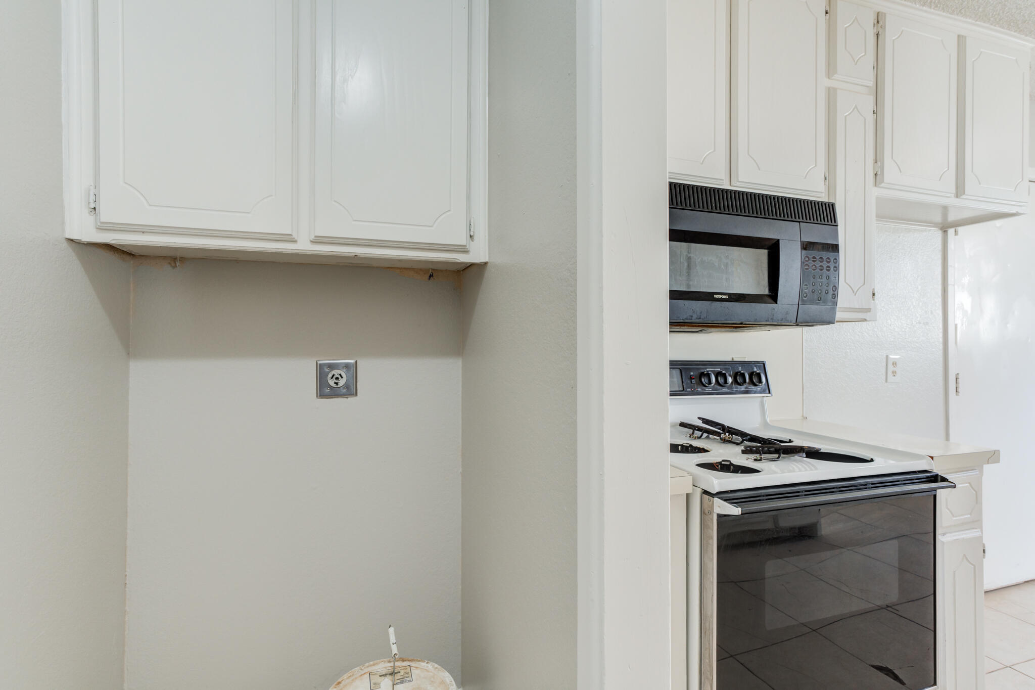 6212 22nd Street Lubbock, TX 79407 - Photo 14 of 24 a kitchen with stainless steel appliances white cabinets and a stove