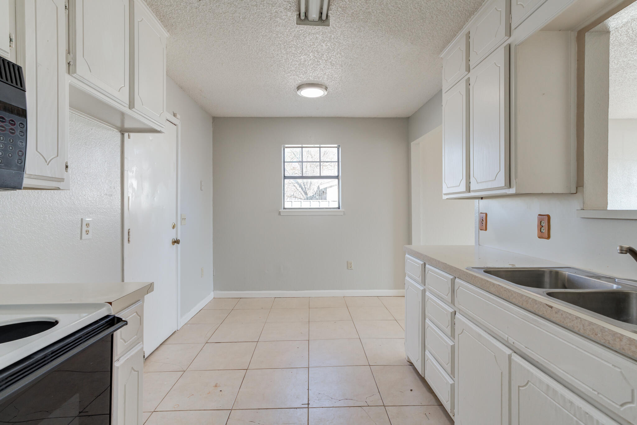 6212 22nd Street Lubbock, TX 79407 - Photo 15 of 24 a kitchen with a sink and cabinets