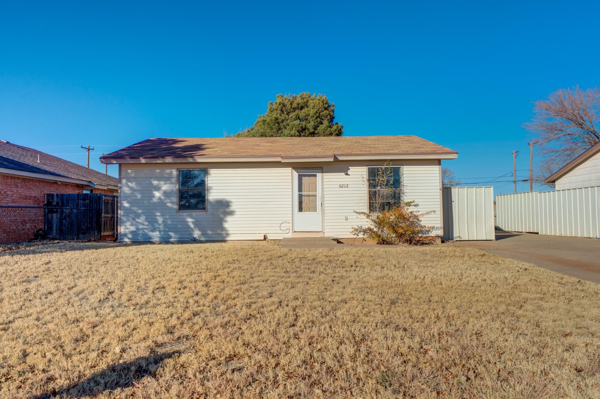 6212 22nd Street Lubbock, TX 79407 - Photo 2 of 24 a front view of a house with a yard