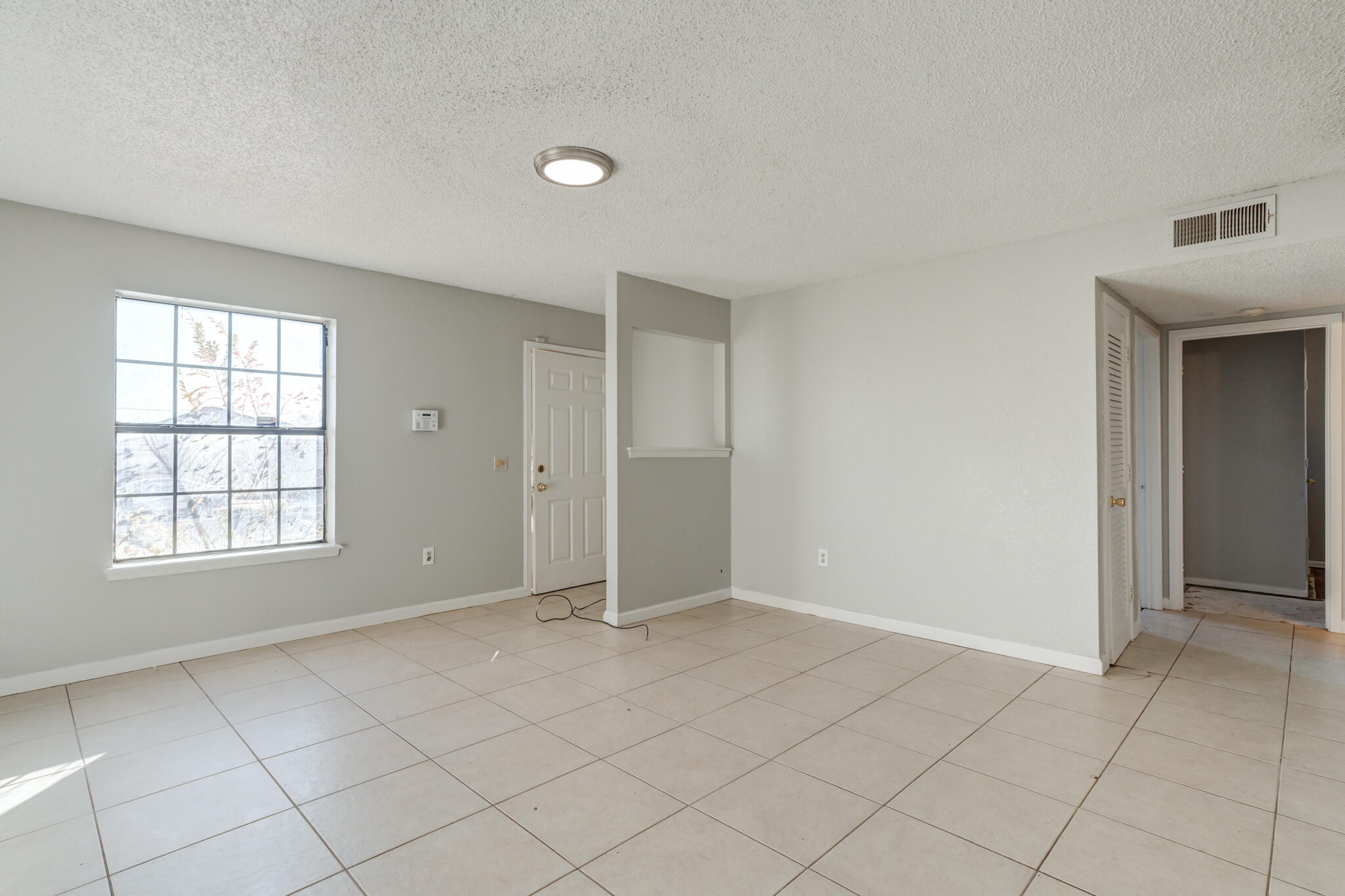 6212 22nd Street Lubbock, TX 79407 - Photo 8 of 24 an empty room with windows