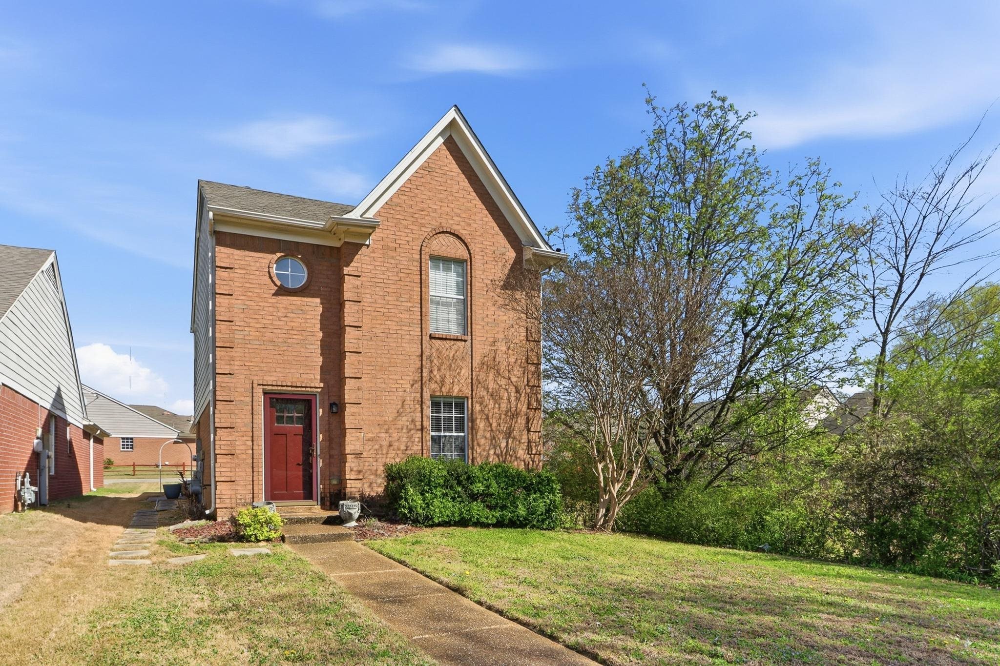 1066 Whitten Road Cordova, TN 38018 - Photo 1 of 30 a front view of a house with a yard
