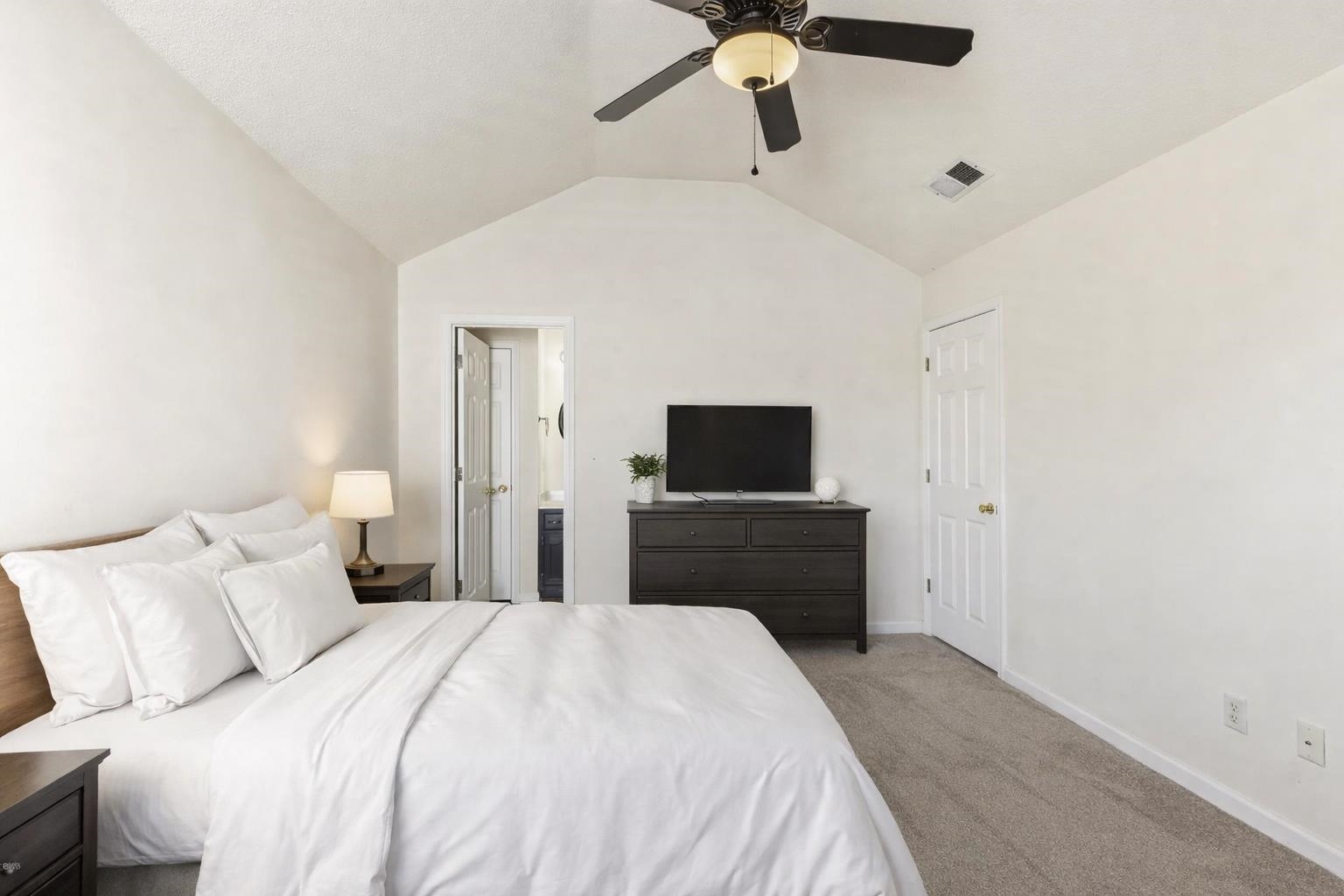 1066 Whitten Road Cordova, TN 38018 - Photo 14 of 30 a bedroom with a bed and a flat screen tv