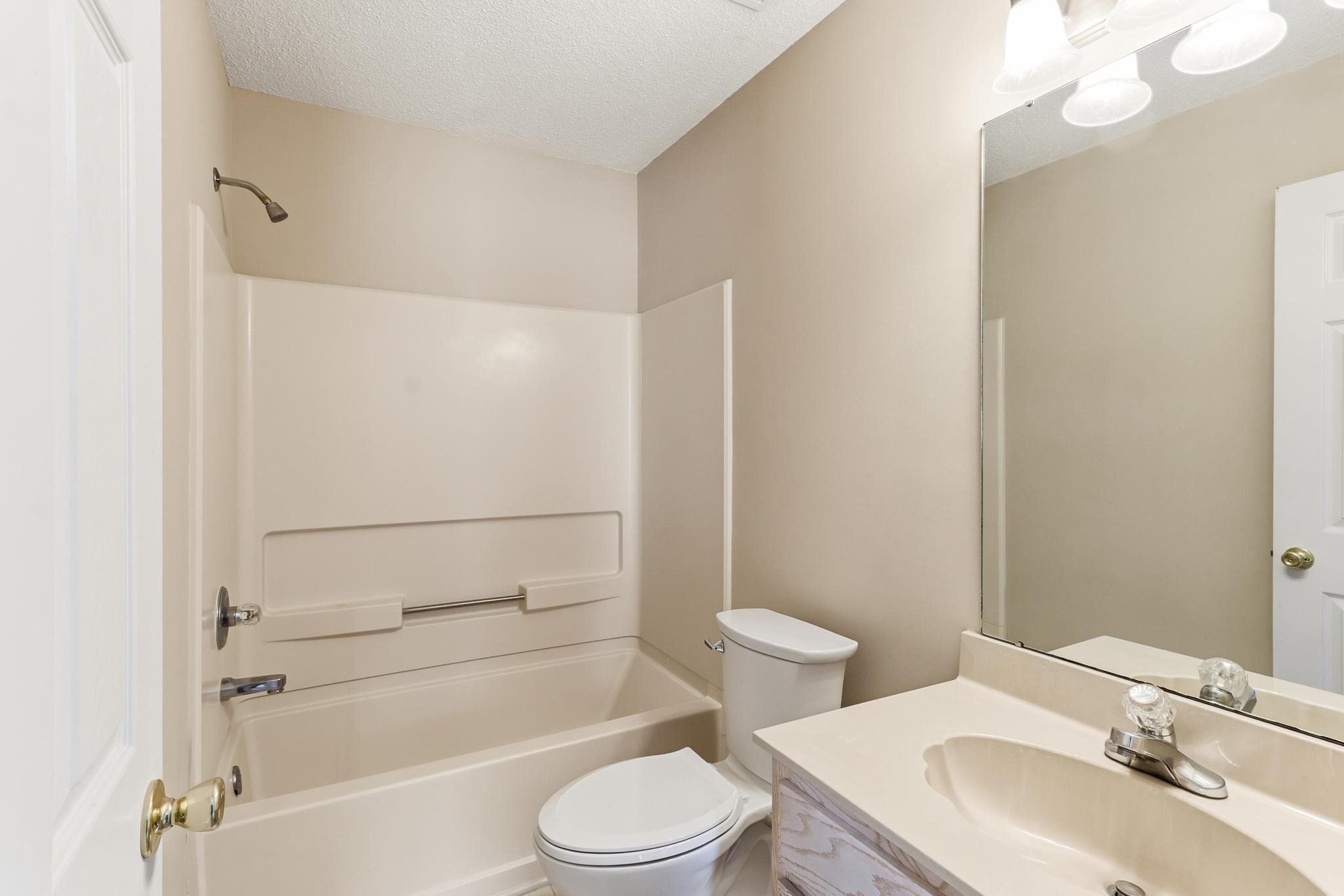 1066 Whitten Road Cordova, TN 38018 - Photo 22 of 30 a bathroom with a sink toilet vanity and shower
