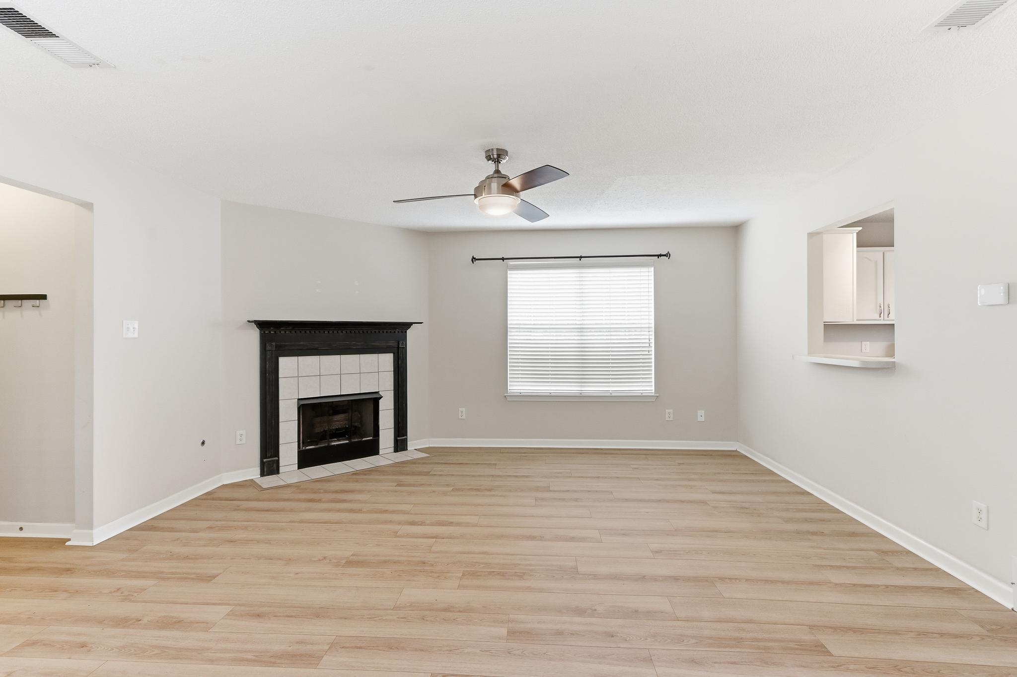 1066 Whitten Road Cordova, TN 38018 - Photo 5 of 30 a view of empty room with a fireplace and wooden floor