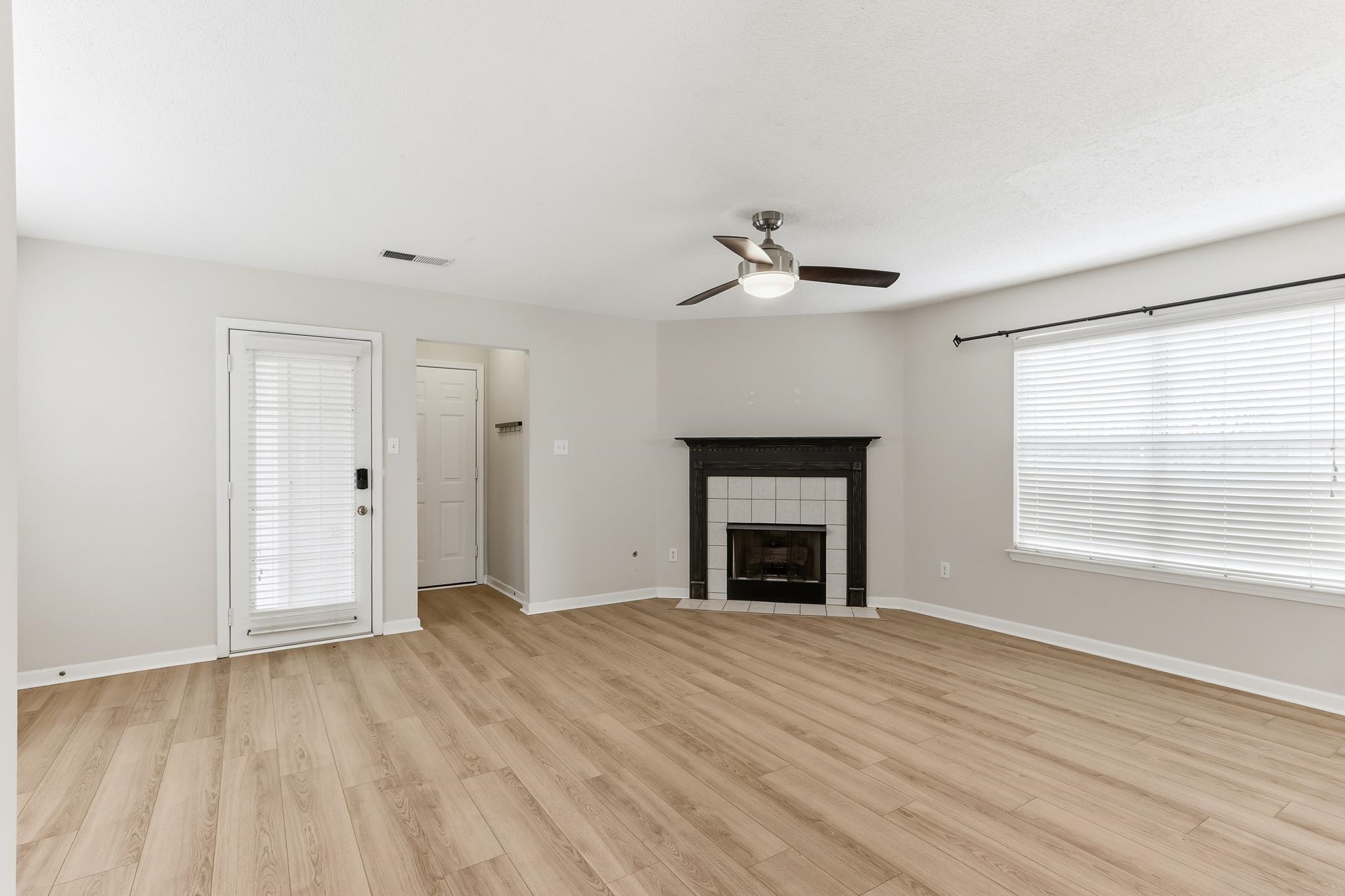 1066 Whitten Road Cordova, TN 38018 - Photo 6 of 30 a view of an empty room with a fireplace and a window
