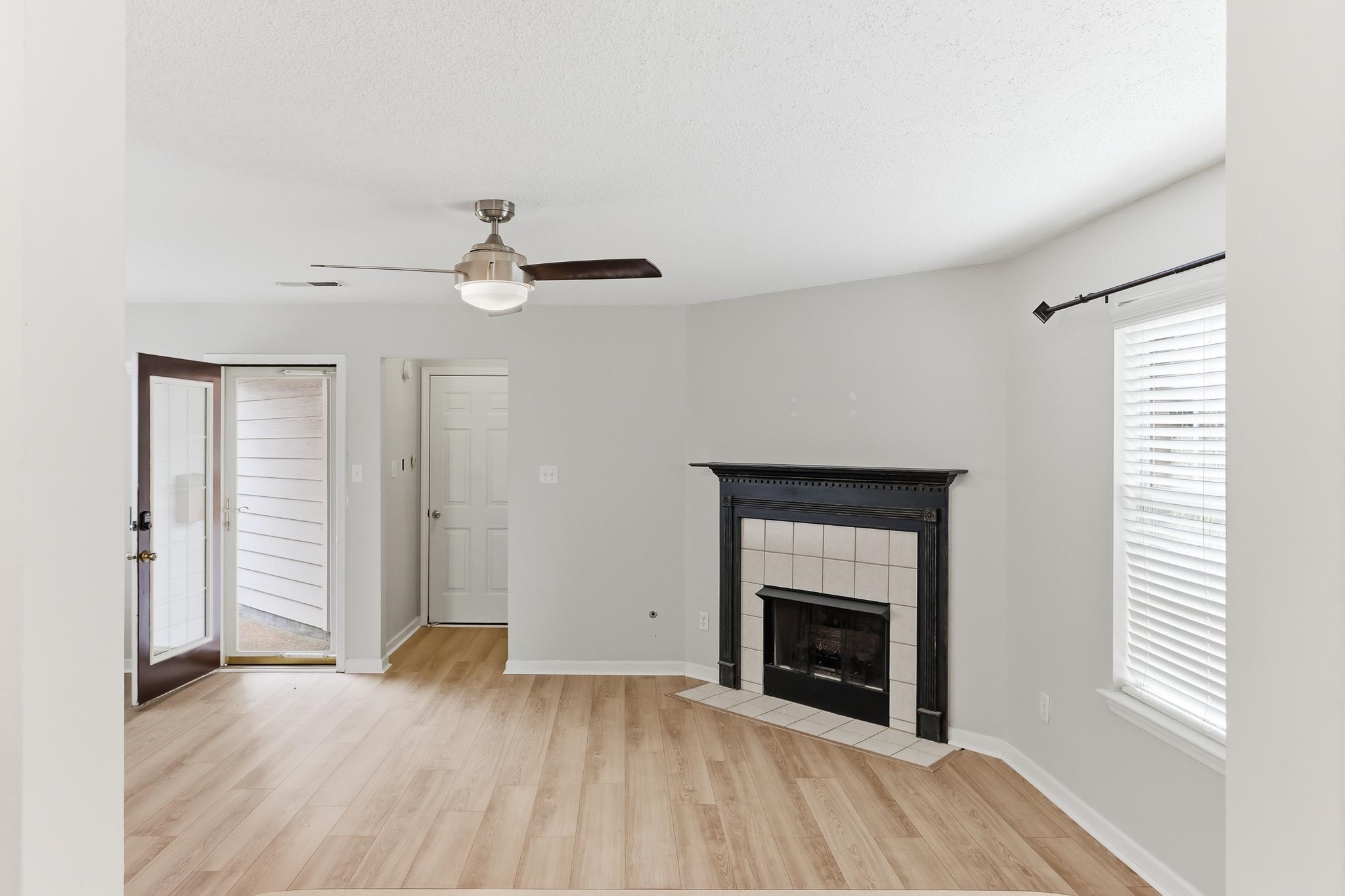 1066 Whitten Road Cordova, TN 38018 - Photo 7 of 30 an empty room with windows and a fireplace