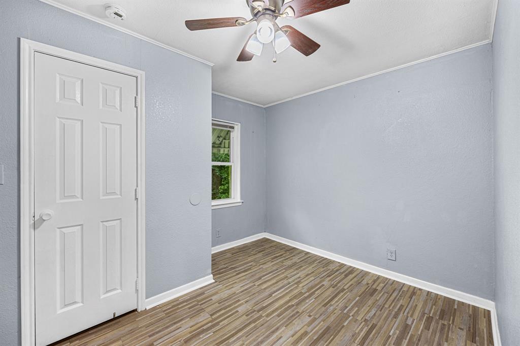 709 Sissom Road Killeen, TX 76541 - Photo 18 of 24 a view of an empty room with wooden floor and a window