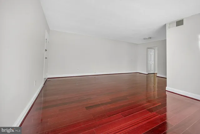 a view of room with window and wooden floor