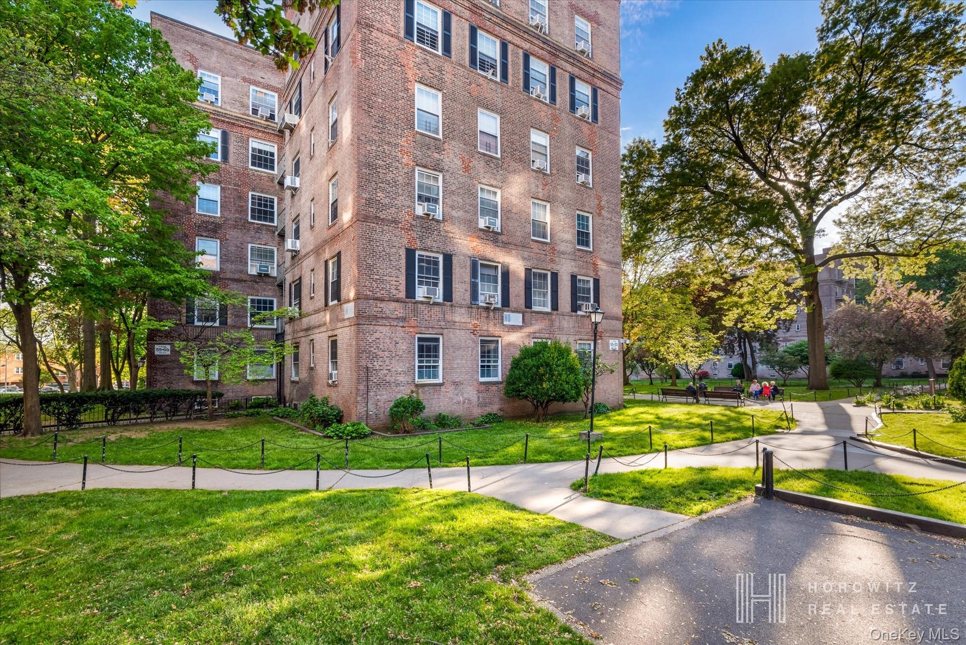 55-03 31st Avenue, Unit C6K Queens, NY 11377 - Photo 9 of 13 a view of a building with a yard