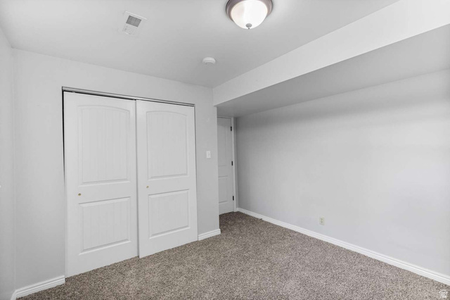 415 East 1150th Street North Logan, UT 84341 - Photo 25 of 38 Spacious room featuring neutral carpeting, a large closet with white sliding doors, a flush-mount ceiling light, and light gray wall paint