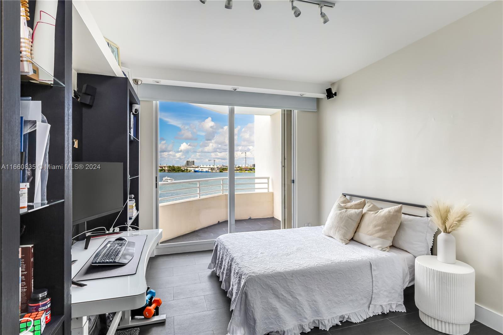 888 Brickell Key Drive, Unit 710 Miami, FL 33131 - Photo 12 of 45 a bedroom with a bed and glass door