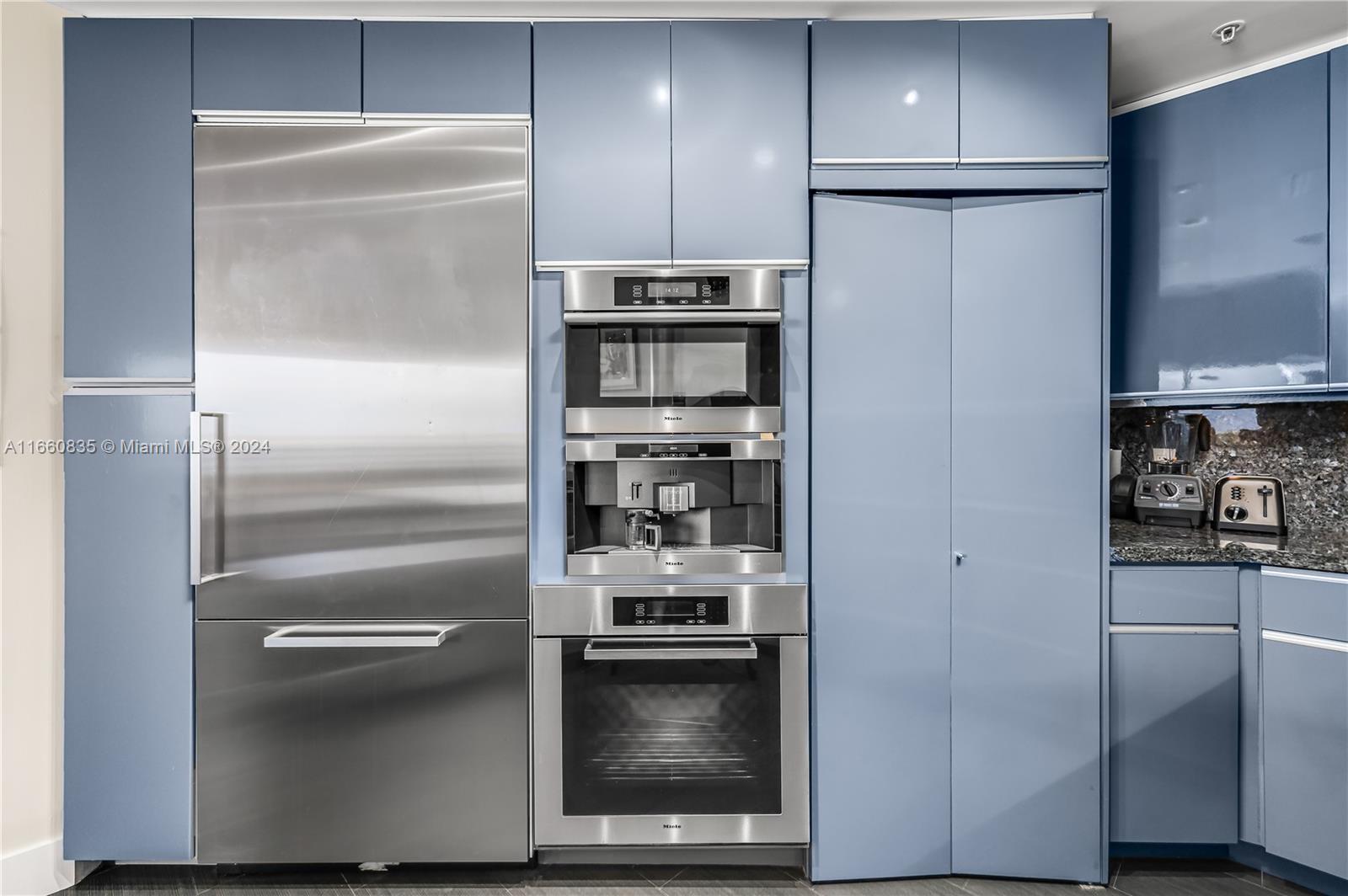 888 Brickell Key Drive, Unit 710 Miami, FL 33131 - Photo 19 of 45 a kitchen with a refrigerator and a stove