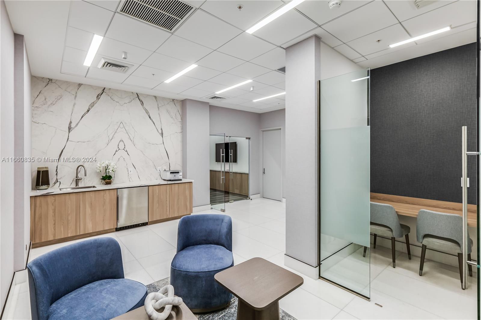 888 Brickell Key Drive, Unit 710 Miami, FL 33131 - Photo 34 of 45 a living room with furniture and wooden floor