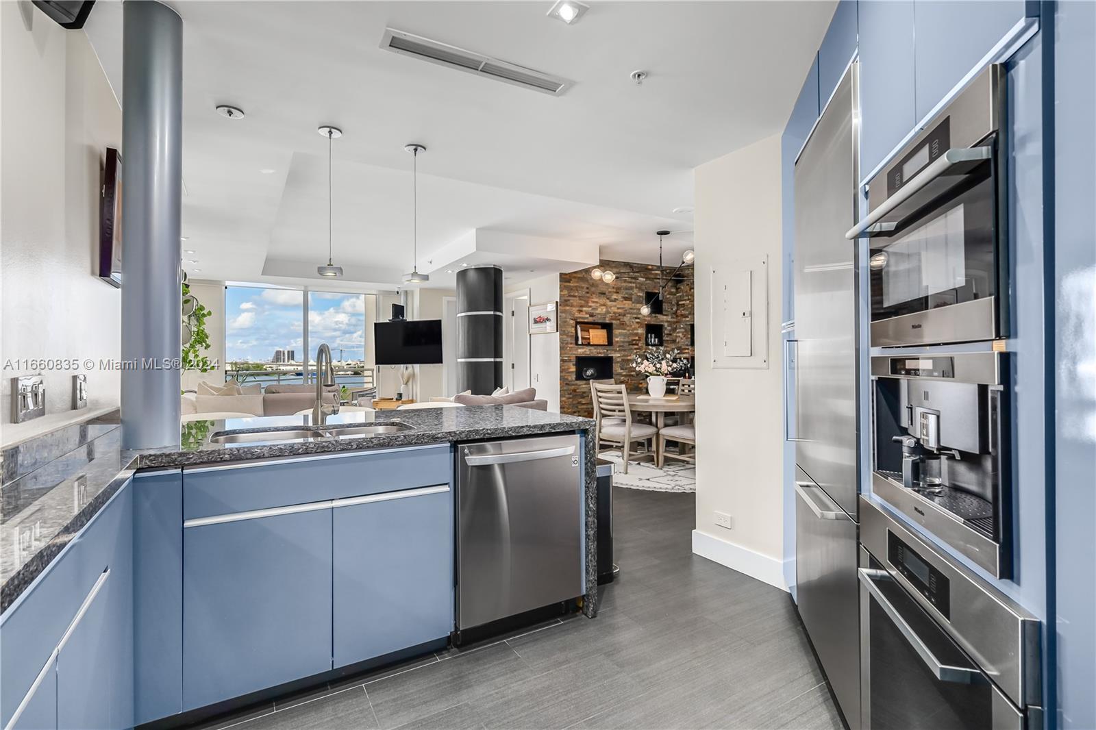 888 Brickell Key Drive, Unit 710 Miami, FL 33131 - Photo 4 of 45 a kitchen with stainless steel appliances a refrigerator and a stove top oven