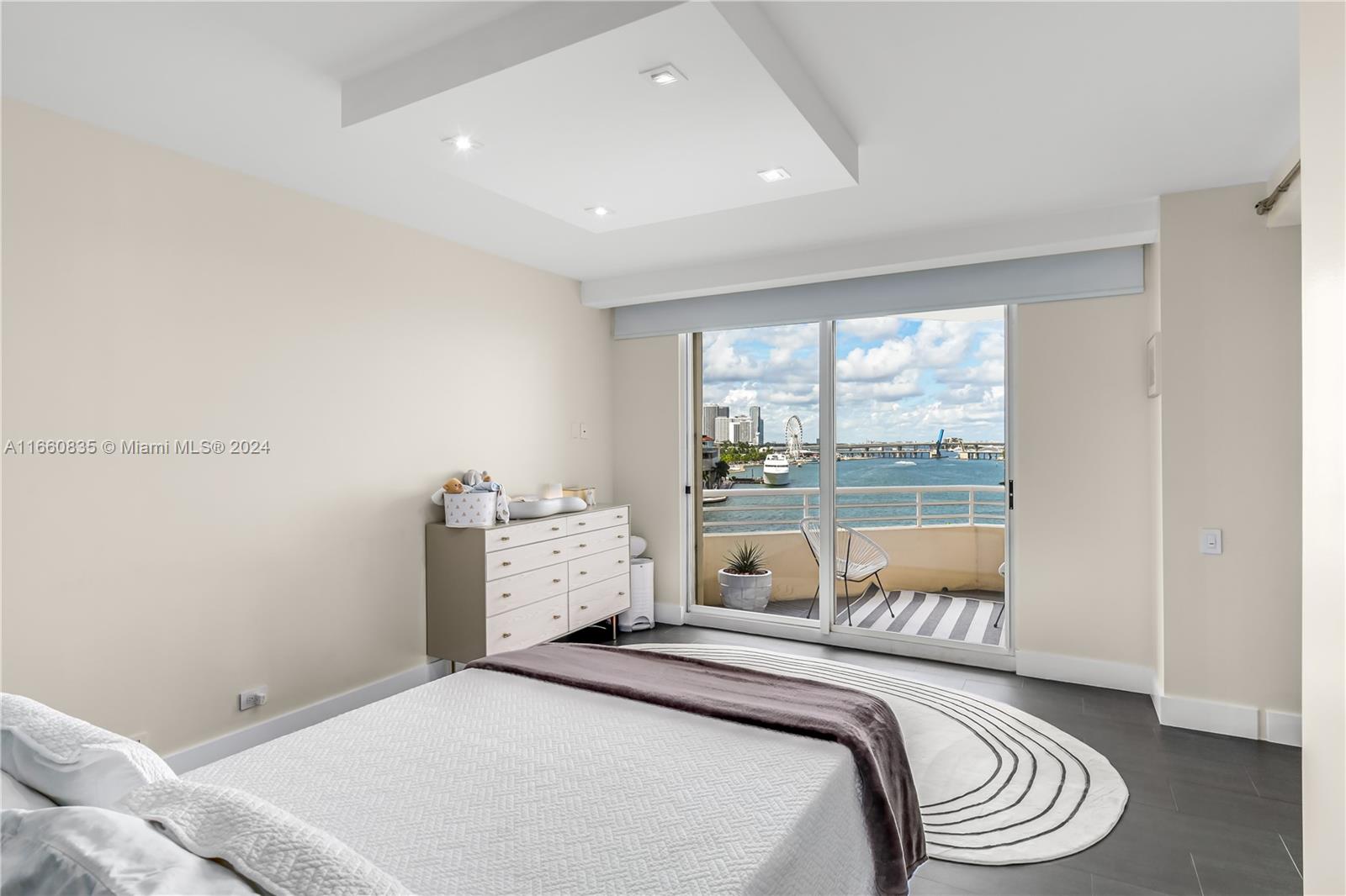 888 Brickell Key Drive, Unit 710 Miami, FL 33131 - Photo 8 of 45 a bed room with a bed and a large window