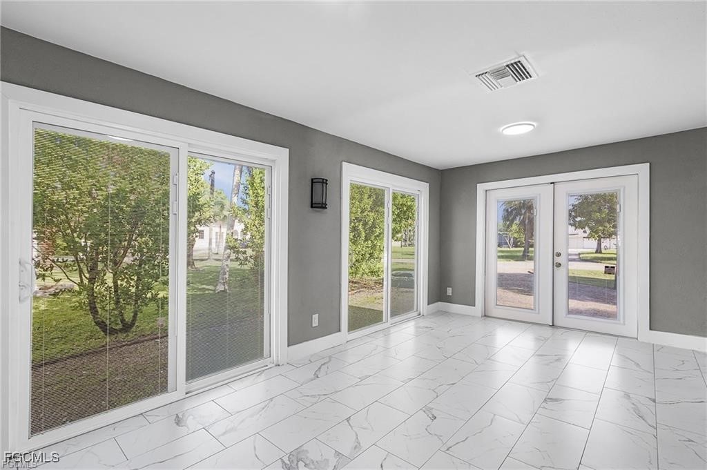4472 East Riverside Drive Fort Myers, FL 33905 - Photo 11 of 17 a view of an empty room with glass door and balcony