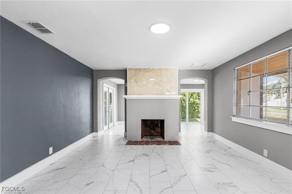 4472 East Riverside Drive Fort Myers, FL 33905 - Photo 12 of 17 an empty room with windows and fireplace