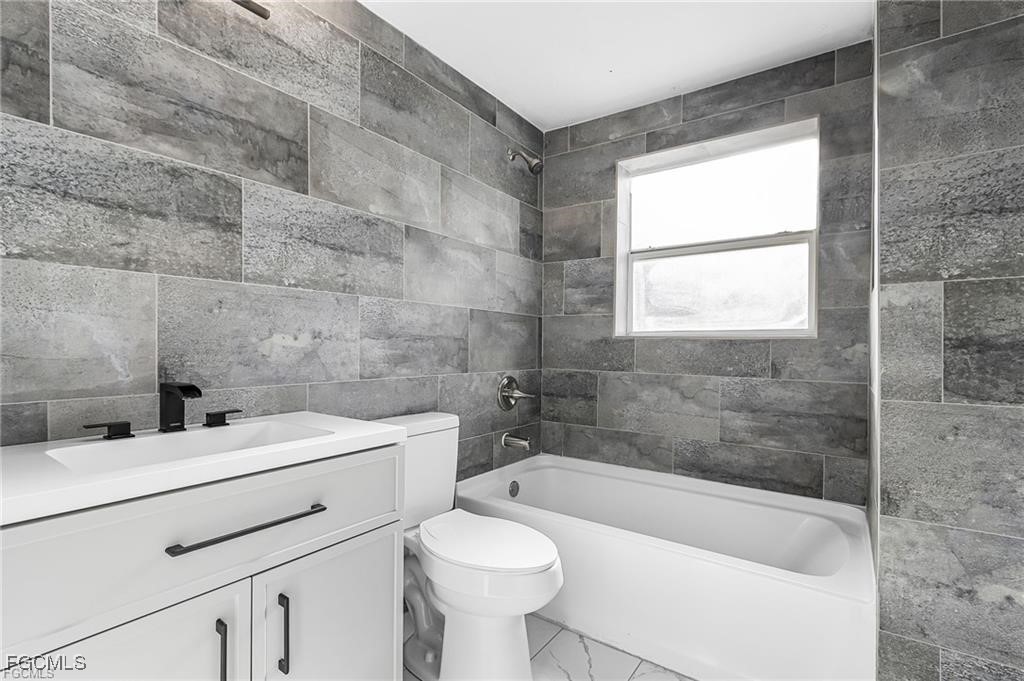 4472 East Riverside Drive Fort Myers, FL 33905 - Photo 9 of 17 a bathroom with a sink a toilet and bathtub