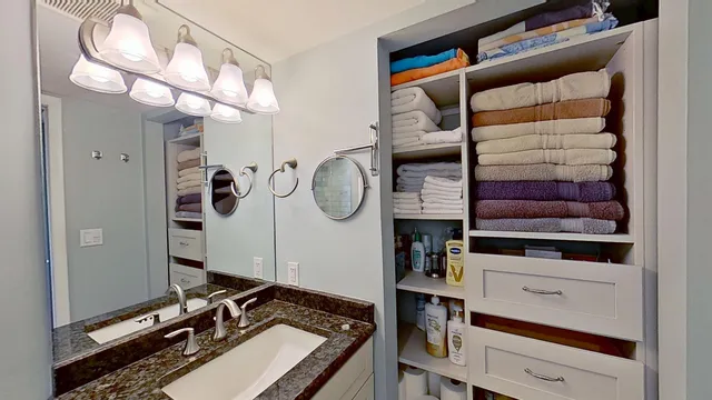 a room with a walk in closet and a mirror