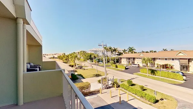 a view of a balcony with furniture and a kitchen