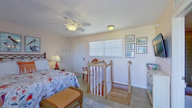 a bedroom with a bed a dresser with mirror and window