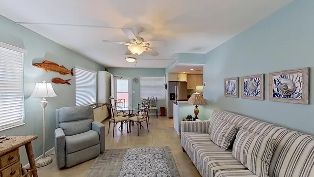 a living room with furniture a couch and paintings on the wall