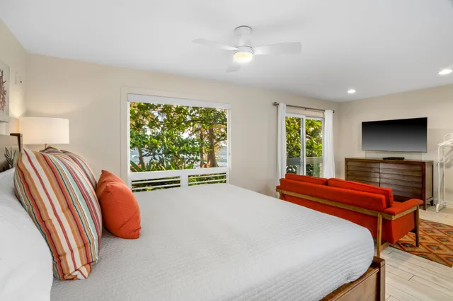 a bedroom with a bed and a flat screen tv
