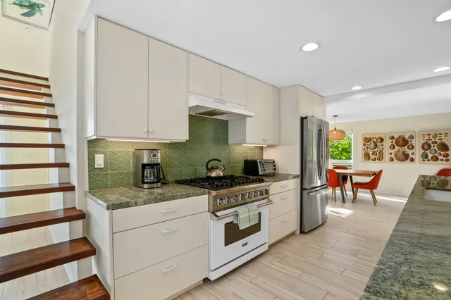 a kitchen with a stove a sink and a refrigerator