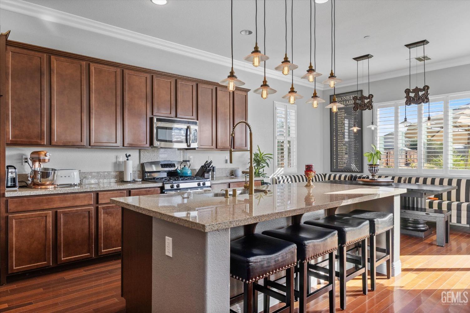 Undisclosed Address Bakersfield, CA 93314 - Photo 21 of 56 a kitchen with a sink stove and cabinets