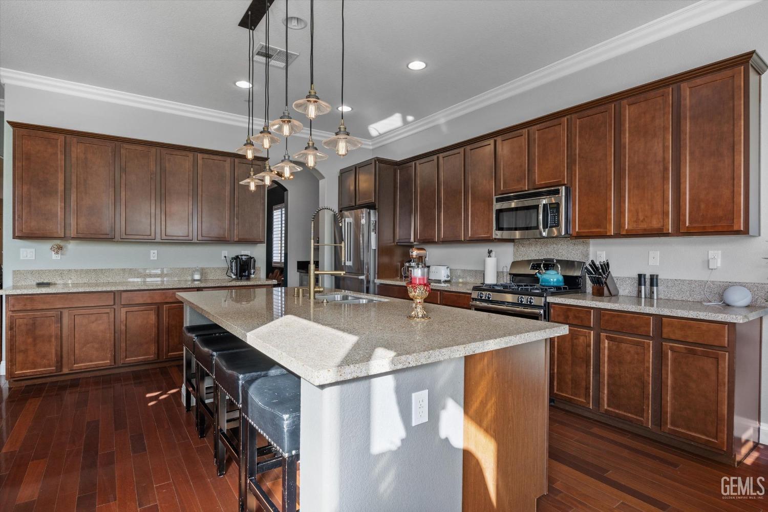 Undisclosed Address Bakersfield, CA 93314 - Photo 23 of 56 a kitchen with kitchen island granite countertop a sink a counter space appliances and cabinets