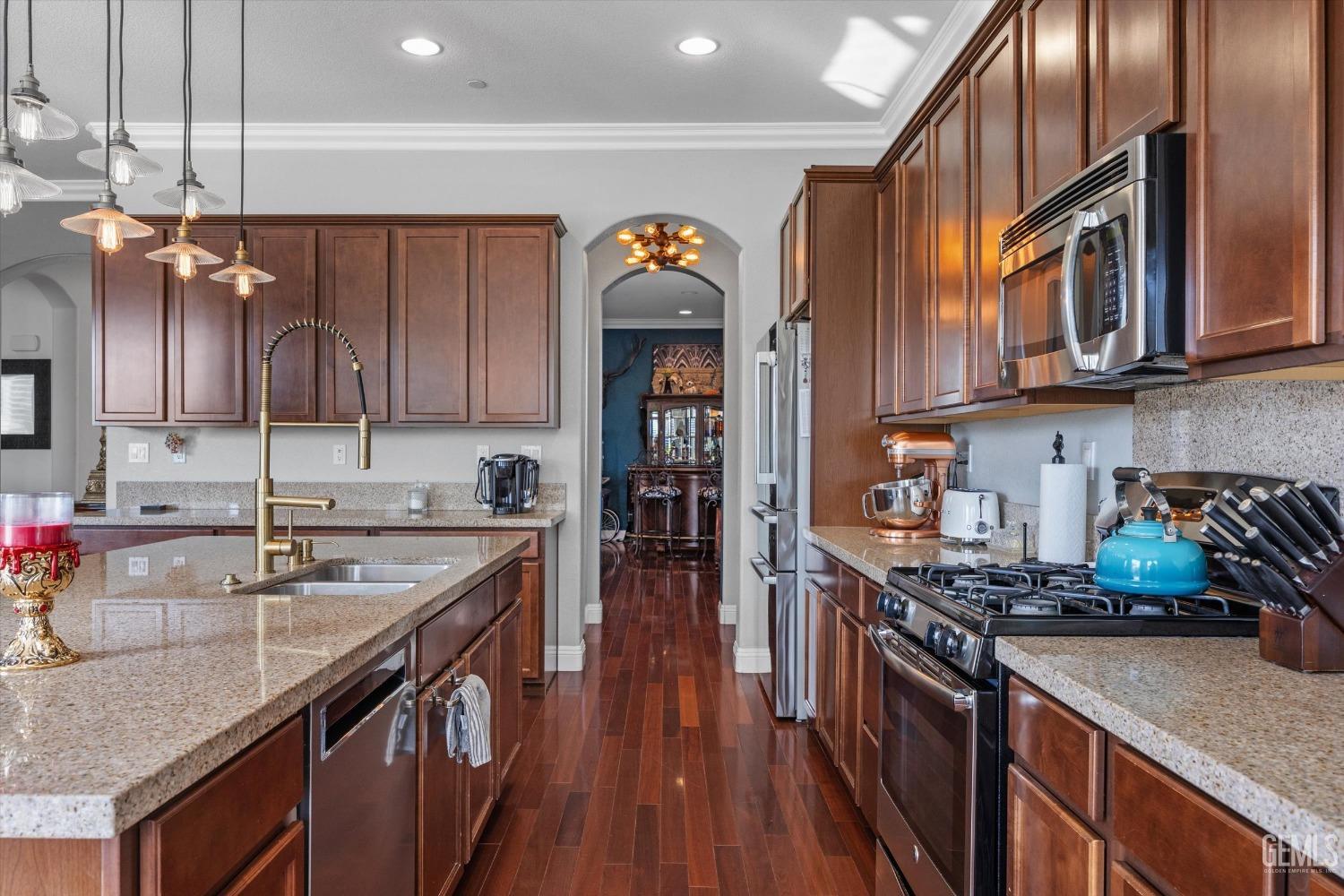 Undisclosed Address Bakersfield, CA 93314 - Photo 24 of 56 a kitchen with stainless steel appliances granite countertop a sink stove and cabinets